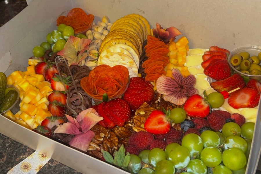Fall charcuterie spread with edible flowers, fruit and crackers